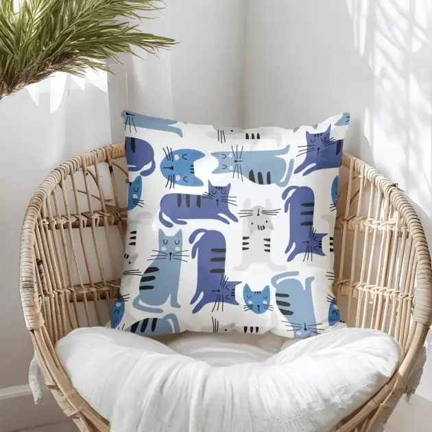 Pillow on bamboo couch with blue cats