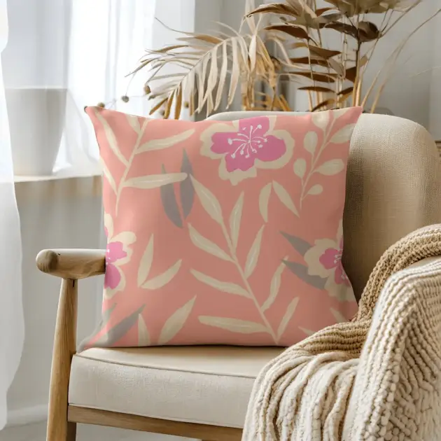 Pillow on bamboo couch with pink flowers and leaves